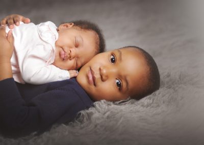 baby on chest of sibling