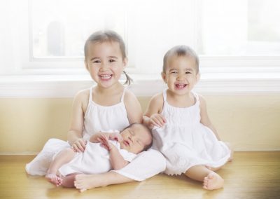 older siblings and newborn